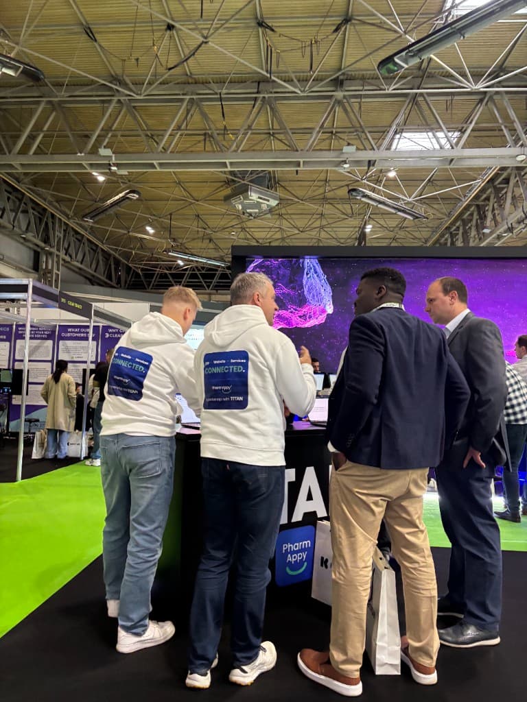 Pharmacy professionals speaking with the PharmAppy team at the exhibition stand